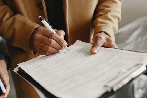man signing employment agreement